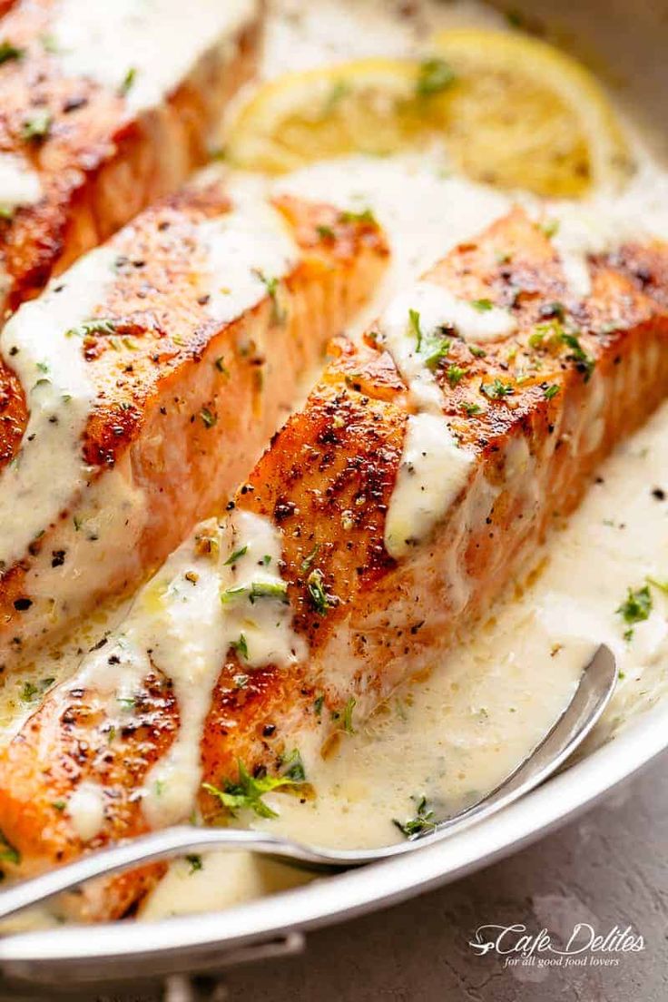 the salmon is covered in sauce and garnished with parmesan on top