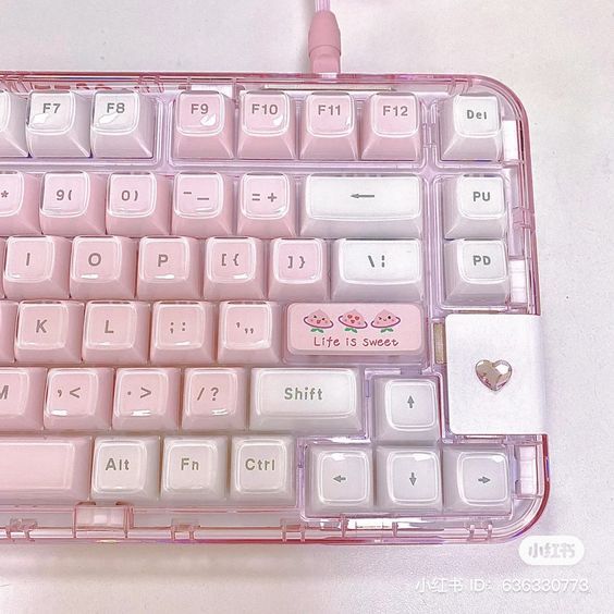 a pink and white computer keyboard with hearts on it's backliting keys