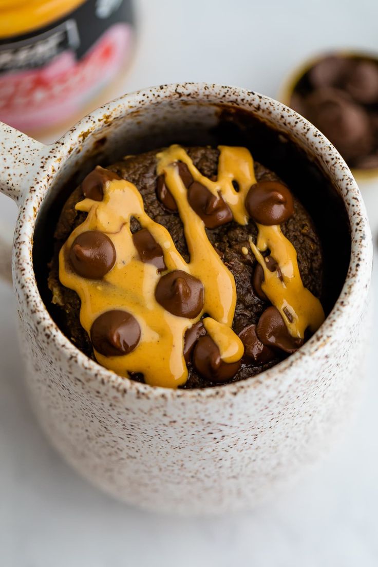 a mug filled with chocolate and yellow frosting