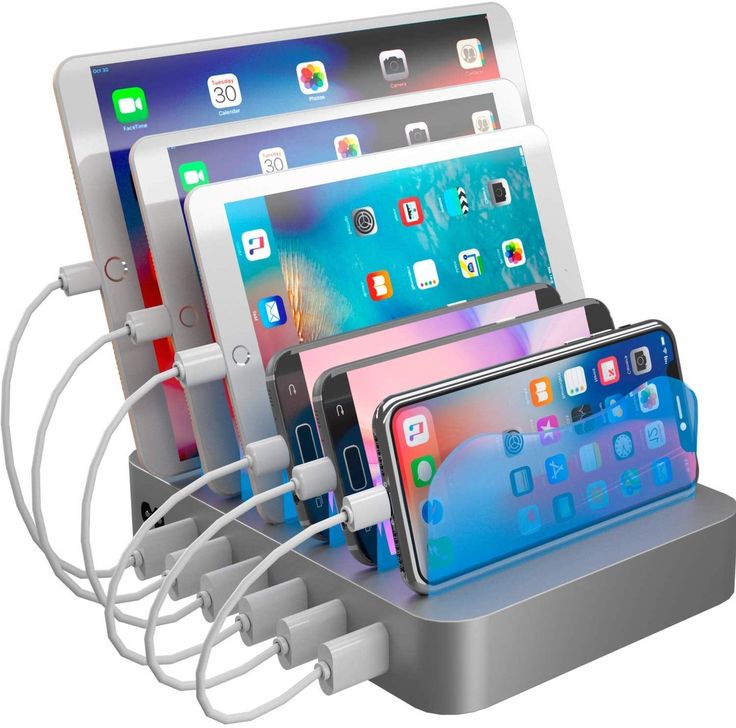 there are many electronic devices connected to each other in this device charging station that is attached to an ipad and macbook