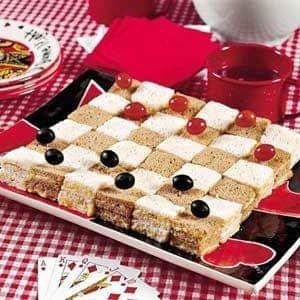 a cake made to look like a checkerboard with cherries on the top