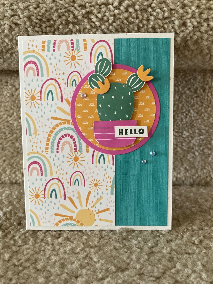 a card with a cactus and rainbows on it