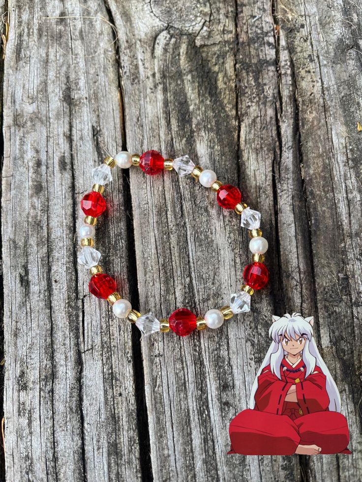 InuYasha anime inspired bracelet. Made with recycled beads from old jewelry. Bracelet is 8inches in length on stretchy beading cord. Bracelet is tied closed, but stretchy enough to fit around a hand to be put on. Nezuko Bracelet, Anime Inspired Beaded Jewelry, Anime Bead Bracelet, Genshin Impact Beaded Bracelets, Inuyasha Necklace, Recycled Beads, Beading Cord, Cord Bracelet, Jewelry Bracelet