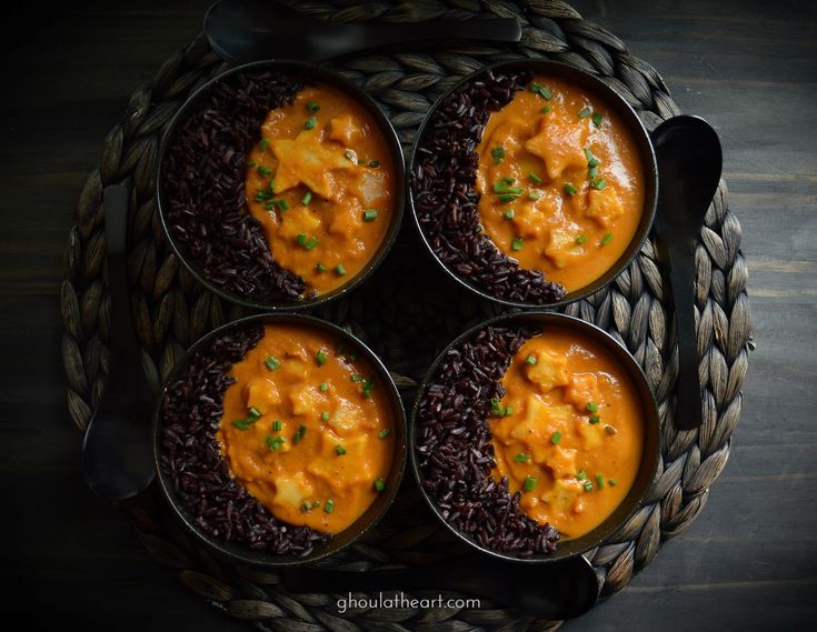 four bowls filled with different types of food on top of rice and spoons next to each other