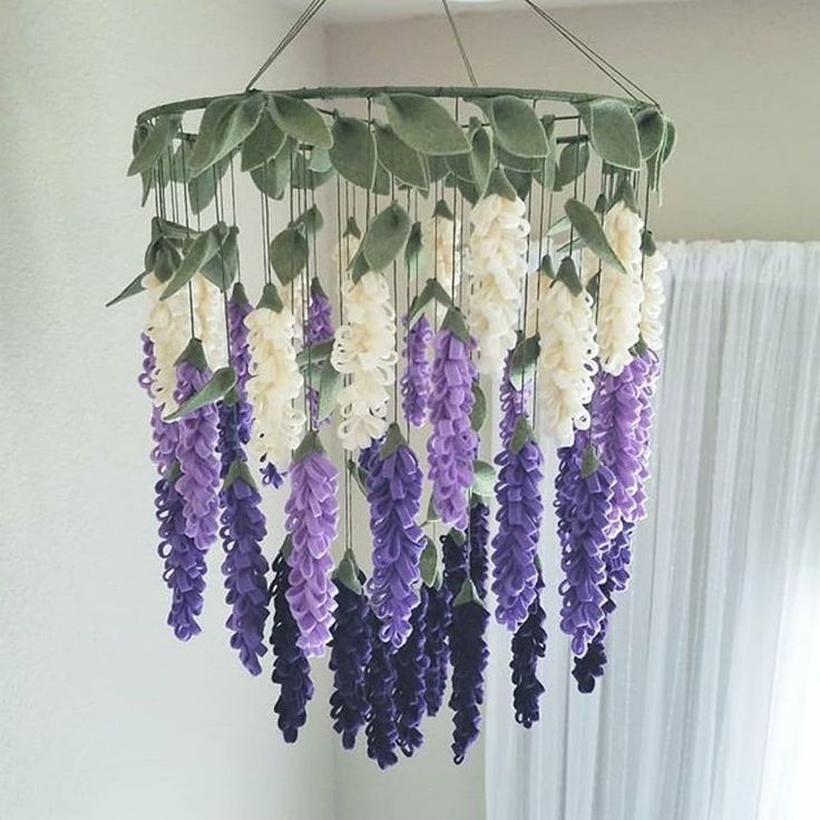 purple and white flowers hanging from the ceiling