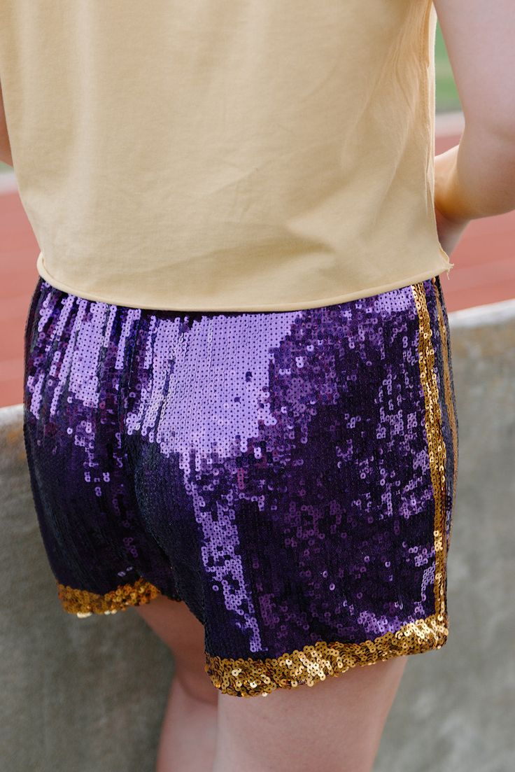 Step out in dazzling style with these Purple & Gold Sequin Jersey Shorts! Featuring eye-catching sequins and LSU colors, while a casual high waist keeps them comfortable and stylish. Ready to sparkle at all of the games? run large with a loose, generous cut plenty of stretch and elastic high-waist style fully lined also available in black/gold model, Macie is 5'2" and wearing a size small Sequin Jersey, Medium Dress, The Games, Gold Models, Gold Sequin, Small Dress, Seville, Purple Gold, Jersey Shorts