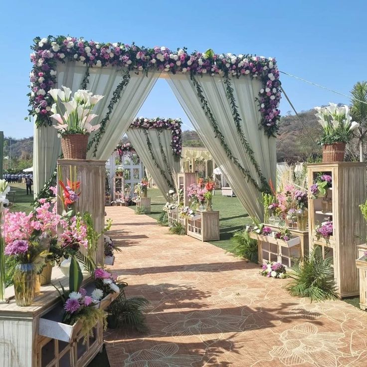 an outdoor wedding setup with flowers and greenery