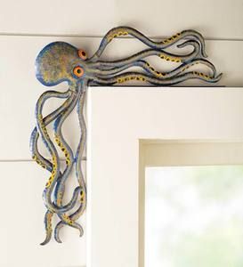 an octopus is hanging on the wall next to a mirror