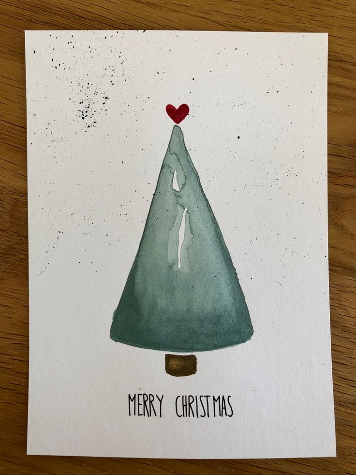 a card with a watercolor christmas tree on it