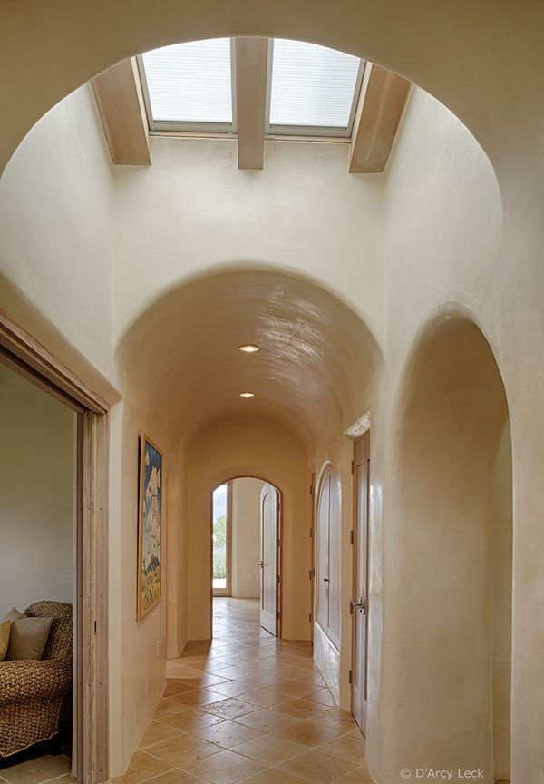 an arched hallway leads to the living room