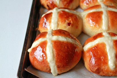 freshly baked hot cross buns on a baking sheet