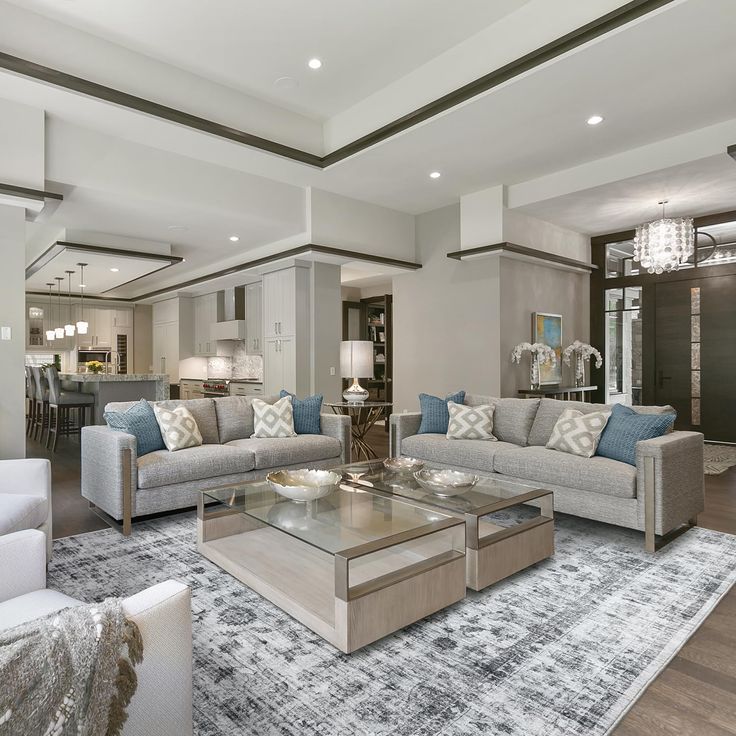 a living room filled with furniture and a chandelier