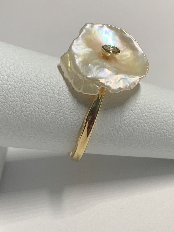 A Lovely 14ky Pearl Flower Ring with a .10ct Diamond center.   Freeform pearl so each one will look different and/or one-of-a-kind! SIZE 7 Makes a great gift! It is best to send with insurance so please message me to add insurance before you purchase.  I will need your address to get the best price.  Thank you! Thanks for shopping with me! Pearl Jewellry, Pearl Flower Ring, Flower Diamond Ring, Pearl Rings, Gold Girl, Pearl And Diamond Ring, Dope Jewelry, Pearl Flower, May 2024