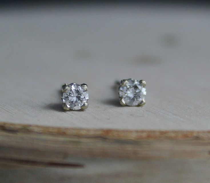 Stunning 14k white gold diamond stud earrings. Each round diamond is .10ct for a .20 TCW. The diamonds are H-I color and SI2 clarity. These earrings come with 14k white gold friction backs. The settings are a decorative stud mounting, sweet and feminine. Each diamond is 3mm in diameter. Perfect set of studs to pair with other earrings or wear on their own. Ready to Ship! Silver Single Diamond Earrings Fine Jewelry, White Gold Platinum Diamond Earrings With Single Diamond, Platinum White Gold Diamond Earrings With Single Diamond, Diamond White Earrings With Prong Setting As Gift, Timeless White Gold Diamond Earrings For Gift, Silver Diamond Earrings With Single Diamond, Timeless White Gold Diamond Earrings As Gift, White Diamond Earrings With Single Diamond, Dainty White Diamond Earrings With Brilliant Cut