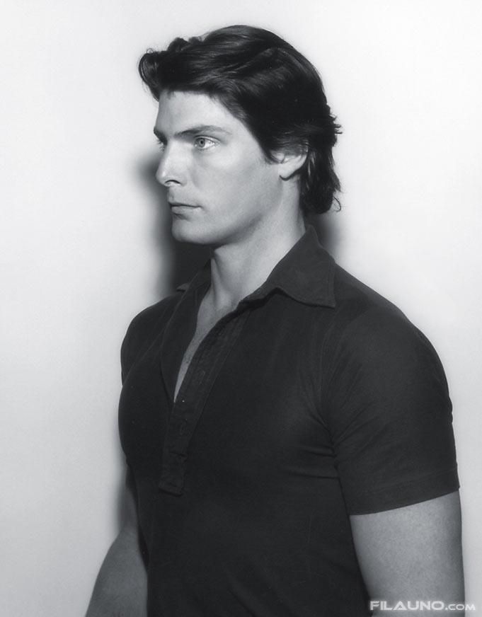 a black and white photo of a man in a polo shirt looking off to the side