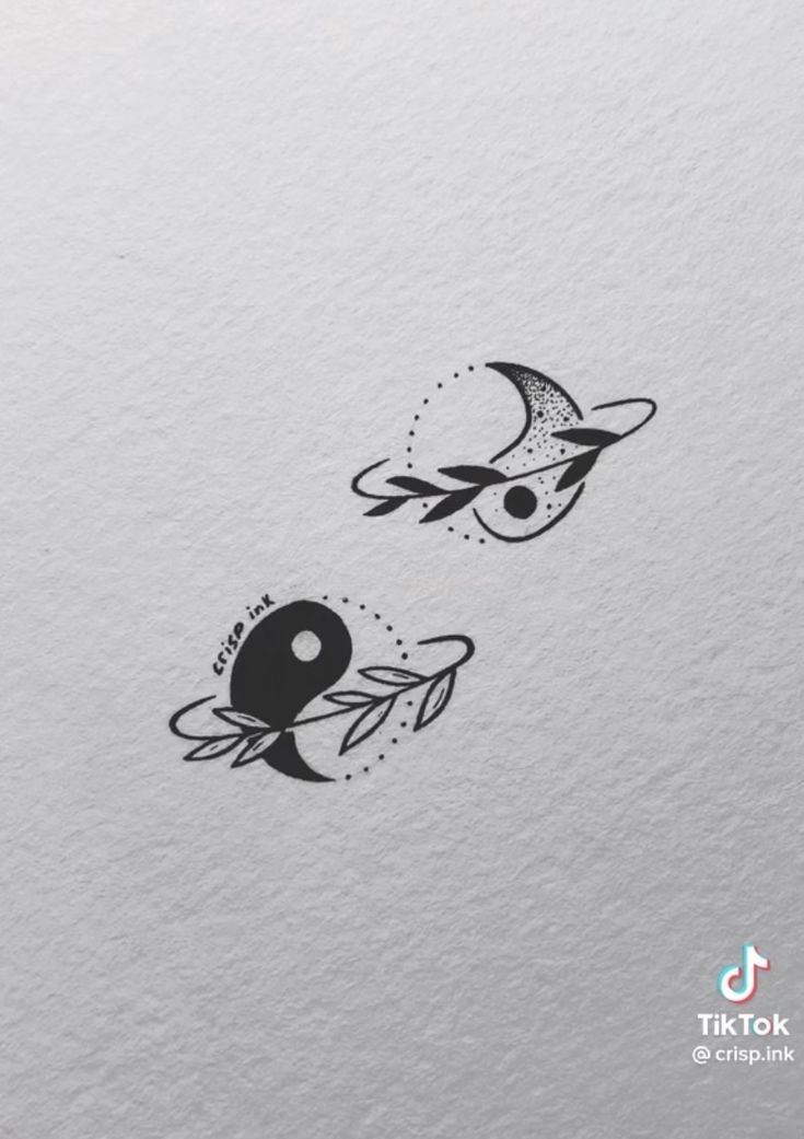 two black and white tattoos on the side of a sheet of paper, one with an eye