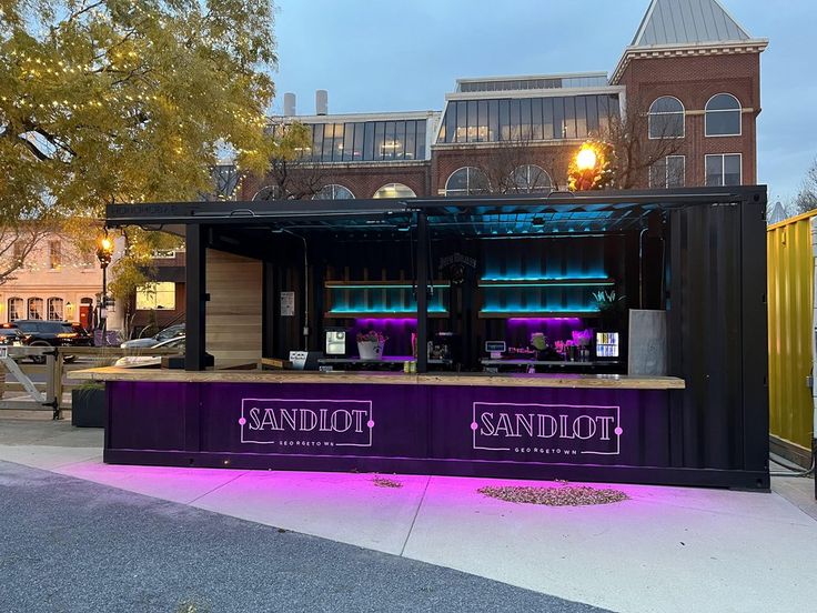 an outdoor stand with purple lighting on it