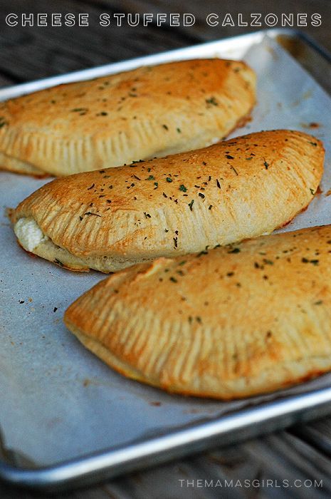 three baked pastries sitting on top of a metal pan