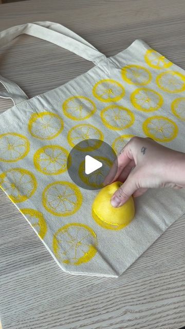 a person is using an object to make a bag with lemons on it,