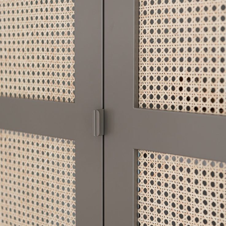 a close up view of a metal door with perfored panels on it's sides