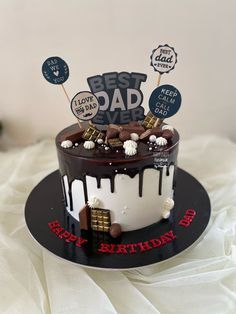 a birthday cake with chocolate and marshmallows on top is decorated with the words best dad