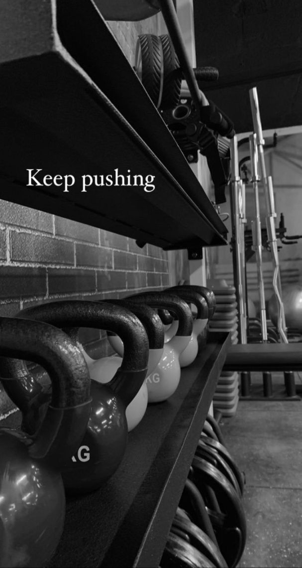 kettles are lined up on a shelf in a gym with the words keep pushing above them