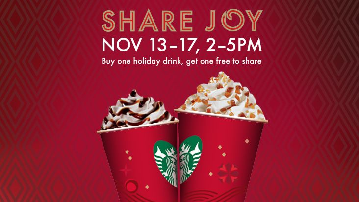 two red cups filled with hot chocolate and whipped cream on top of each other, in front of a red background that says share joy