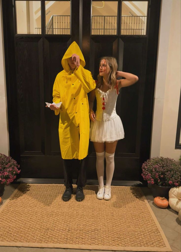 two people dressed in costumes standing next to each other on a door mat and posing for the camera