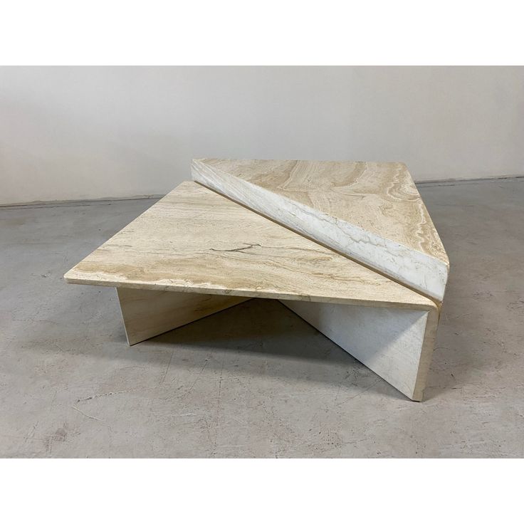 two pieces of wood sitting on top of each other in the middle of a room