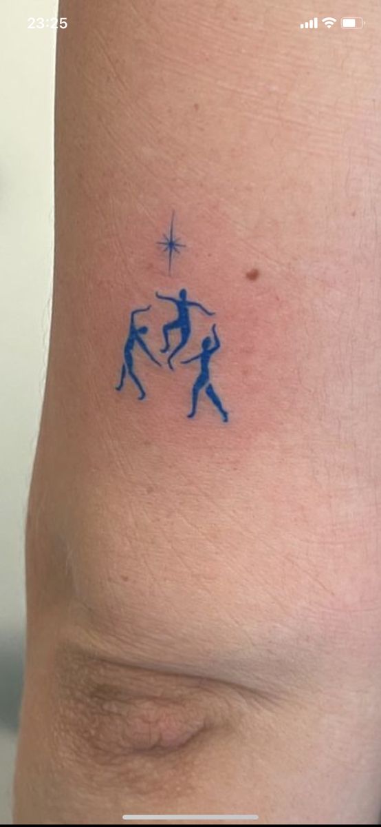 a tattoo on the back of a woman's arm shows two people holding hands