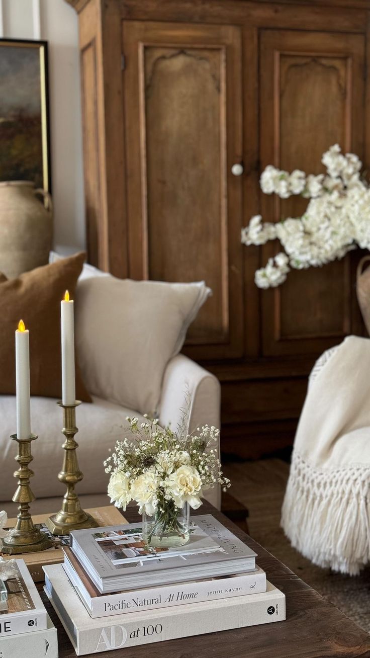 a living room filled with furniture and flowers on top of each other's tables