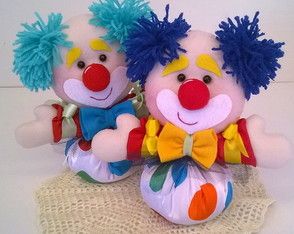 two stuffed clowns sitting next to each other