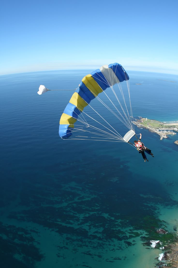 a person is parasailing over the ocean