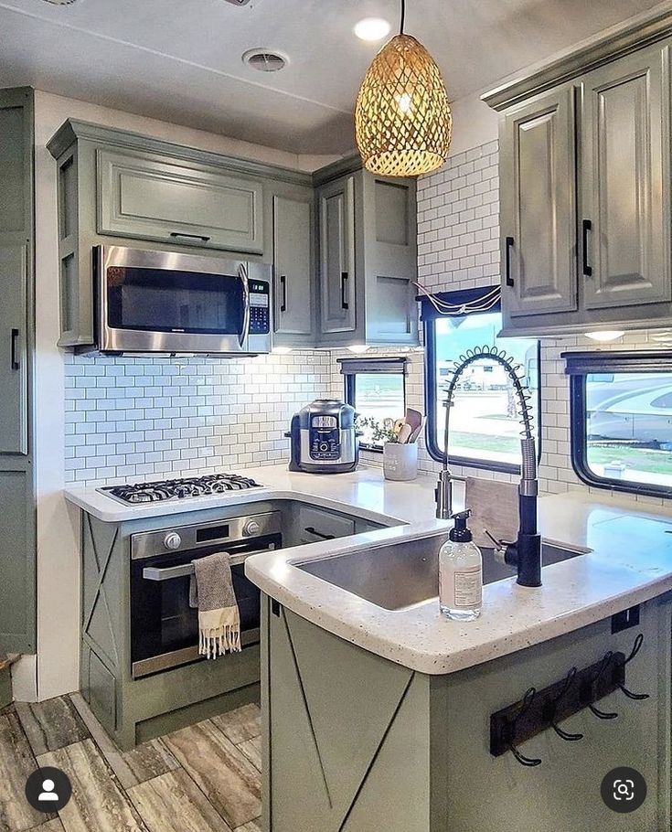 a kitchen with an oven, sink and microwave in it's center island area