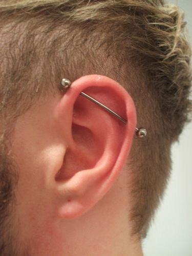 a man with some piercings on his ear