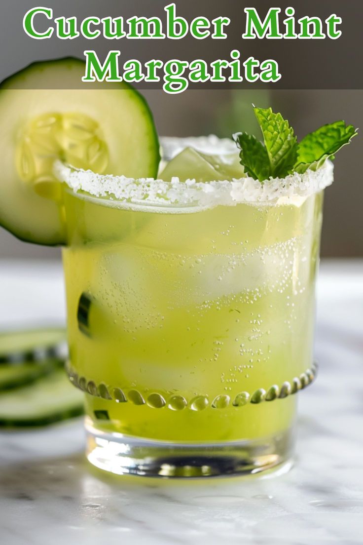 cucumber mint margarita in a glass garnished with lime