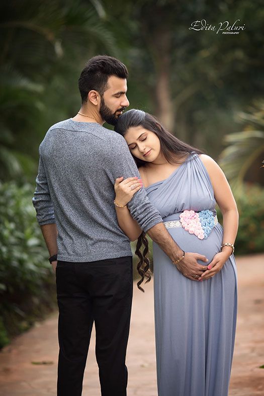 a pregnant couple standing next to each other