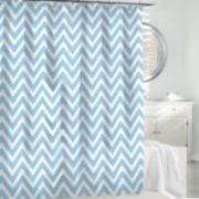 a blue and white shower curtain in a bathroom