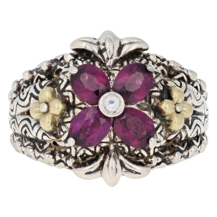 Turn heads your way when you accessorize with this stunning designer ring! Created by Barbara Bixby in sterling silver with accents of 18k yellow gold, the ring showcases a genuine white topaz solitaire and four natural Rhodolite garnets. Textured gold flowers, polished silver beads, and decorative detailing on the sides of the band add to the ring's exotic look. This ring is a size 7. Metal Content: Guaranteed Sterling Silver & 18k Gold as stamped Stone Information: Genuine Rhodolite Garnets Ge White Sapphire Ring, La Face, Rhodolite Garnet, Garnet Rings, Gold Texture, White Sapphire, Gold Flowers, Topaz Ring, White Topaz