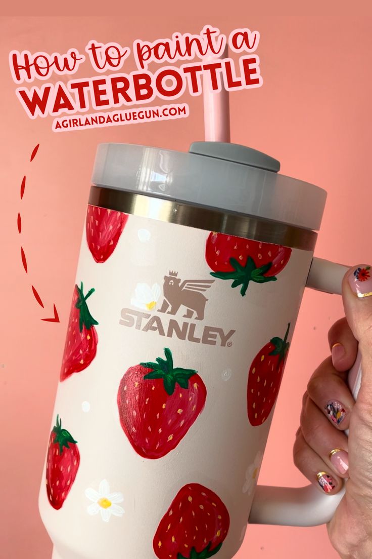 a woman holding up a coffee cup with strawberries on it