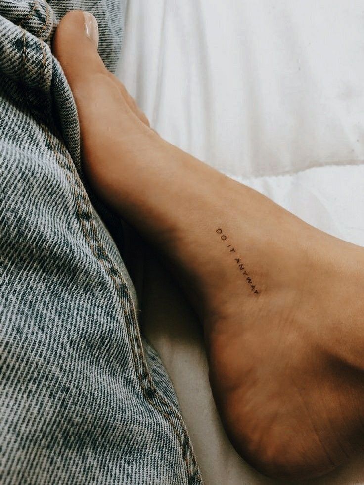 a person's foot with the word love written on it in cursive writing