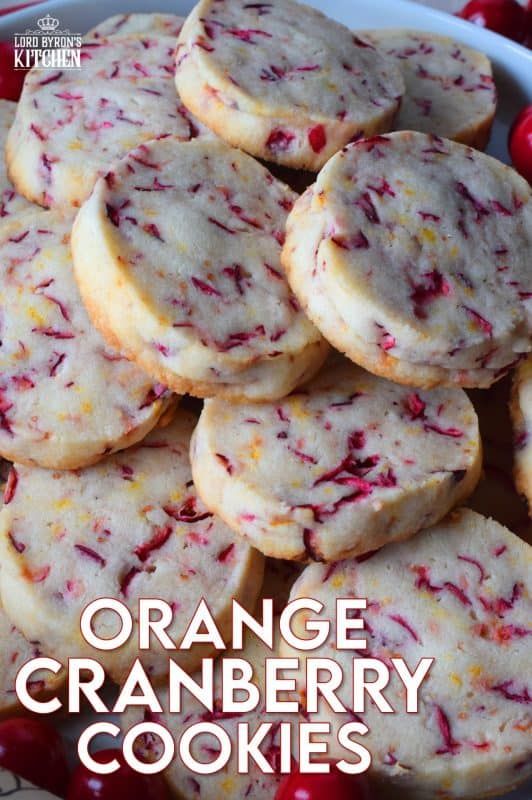 orange cranberry cookies in a bowl with cherries on the side and text overlay reading orange cranberry cookies