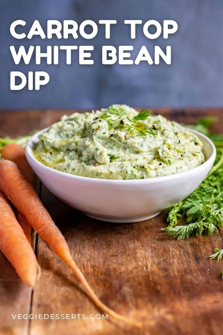 carrots and guacamole dip in a white bowl on a wooden cutting board