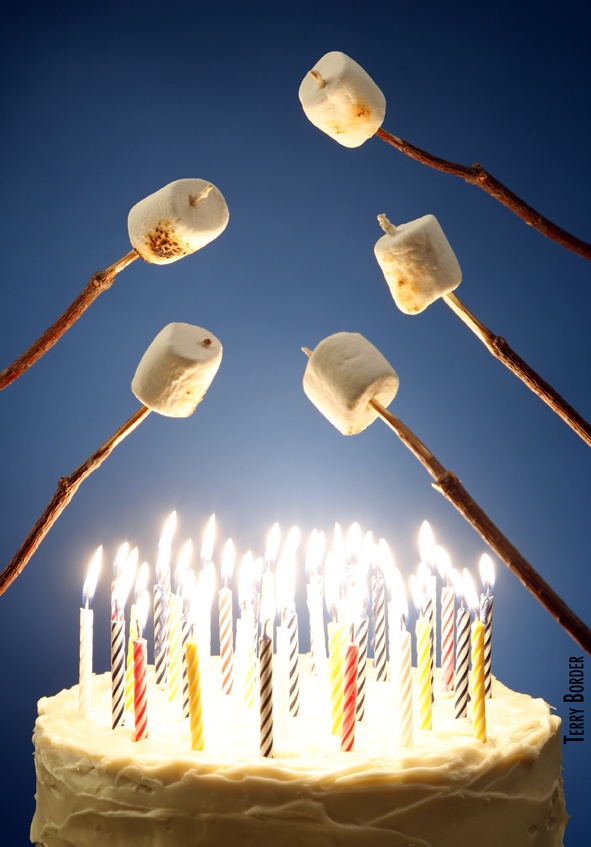 a birthday cake with lit candles on it