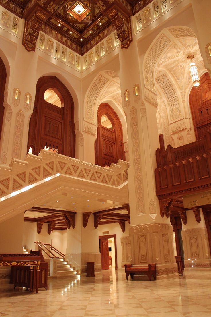 the inside of a large building with many windows and wooden staircases leading up to it