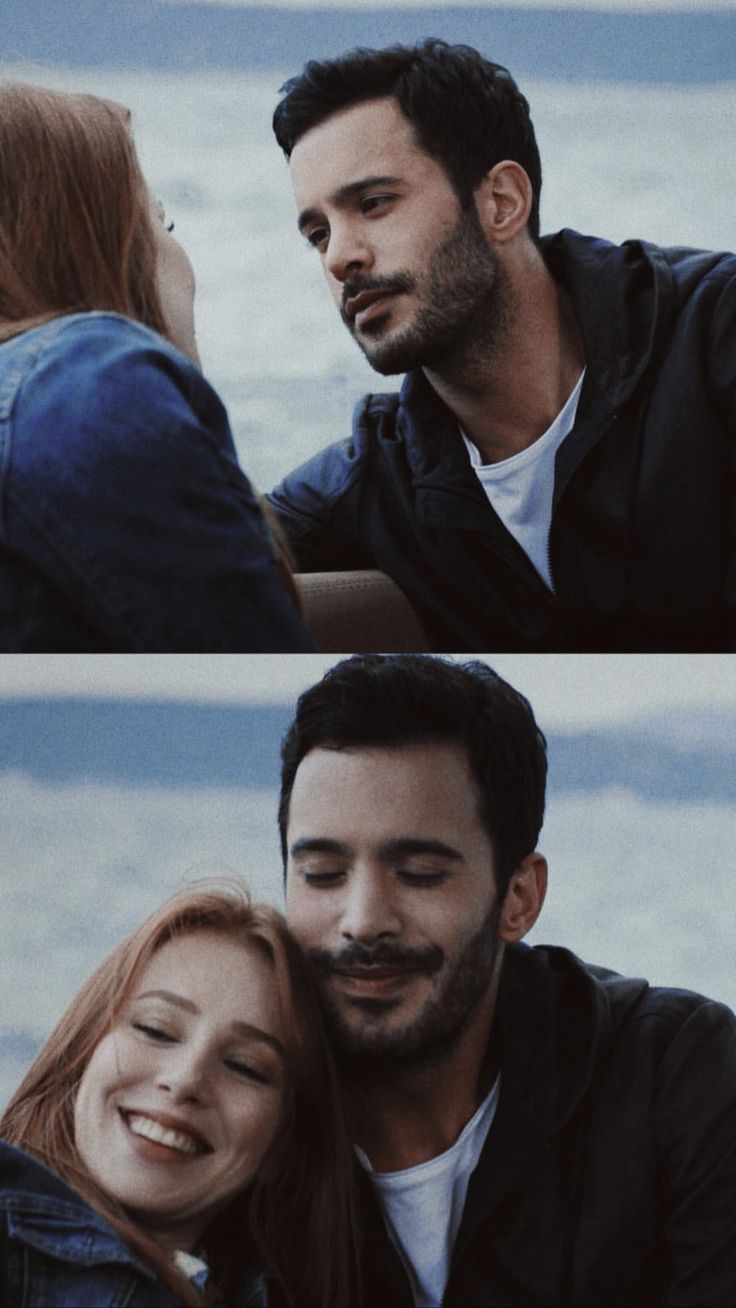 two people sitting next to each other near the ocean