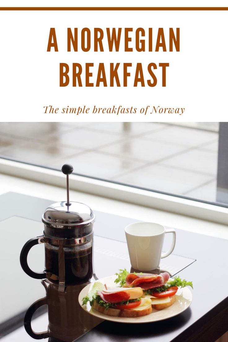 a plate with food on it sitting next to a coffee pot and a glass cup