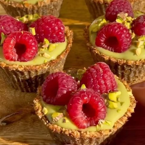 small desserts with raspberries and pistachio on top