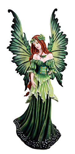 a green fairy figurine with wings