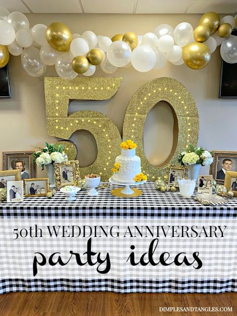 a 50th wedding anniversary party table with balloons and pictures on the table for guests to eat